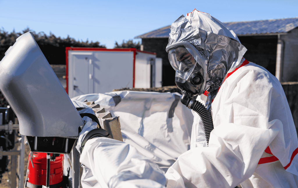 Opérateur S3DE en combinaison Tyvek et masque à ventilation assistée sur un chantier de désamiantage